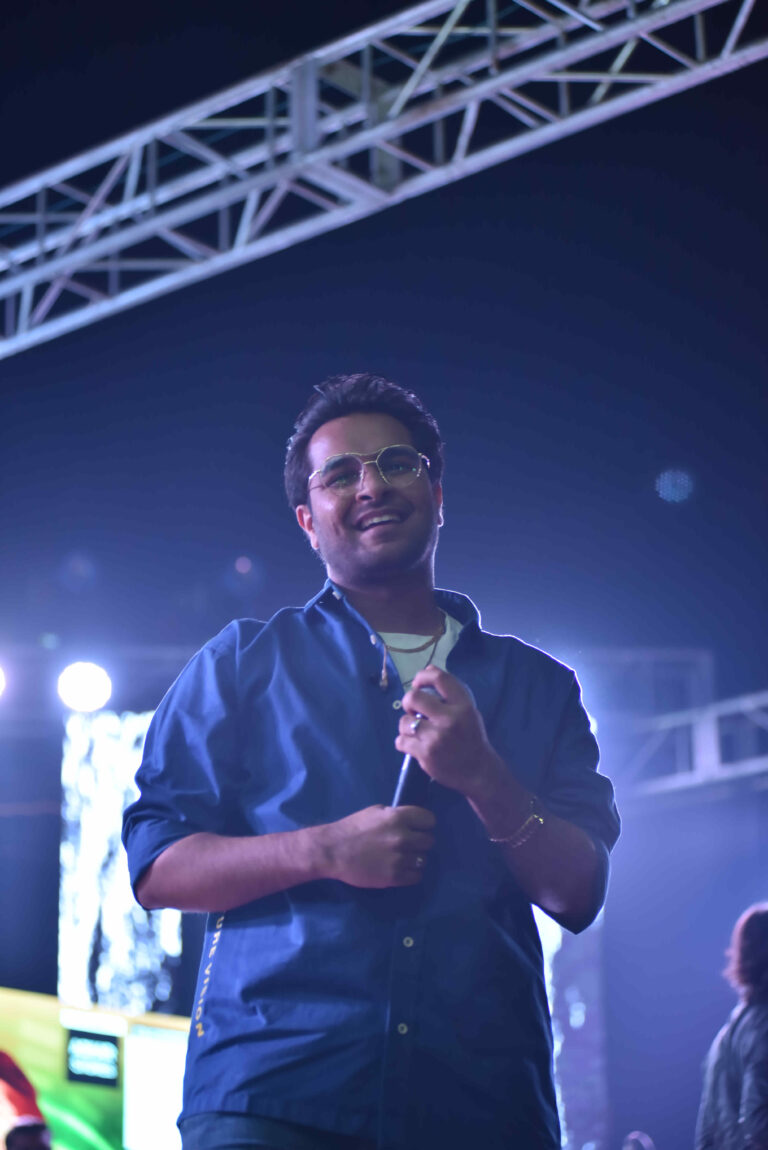 Singer smiling during a Circle Club performance